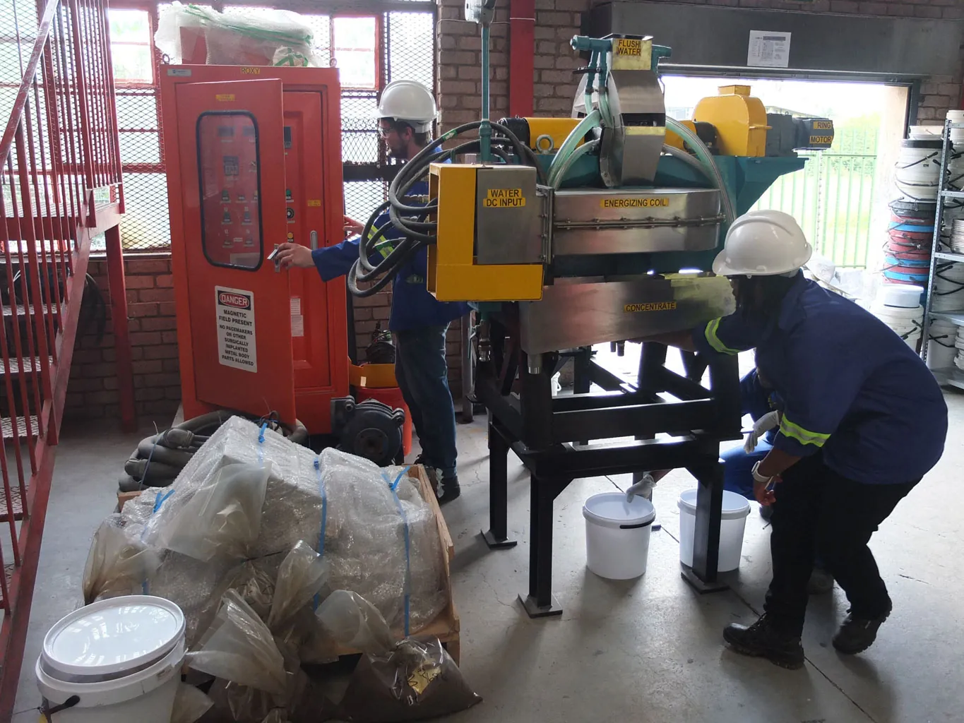 Metanza technical team working on separation equipment in the test facility